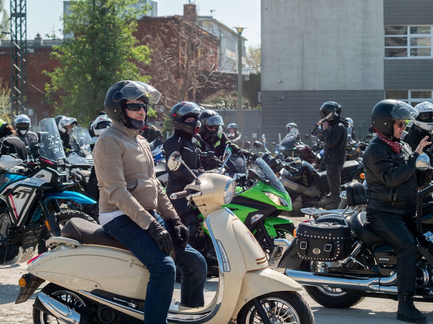 Large group of motorcyclists gathered outdoors in Wrocław, Poland, showcasing diverse bikes and riders.