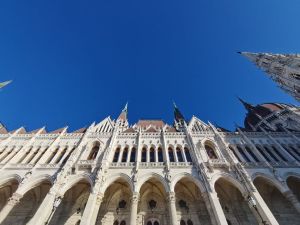 Stunning view of the ornate facade of the Hungarian Parliament Building under a clear blue sky.