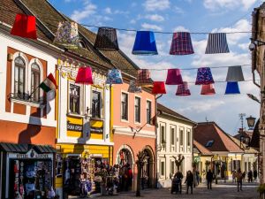 Vibrant street scene in Szentendre with colorful hanging lampshades and charming architecture.