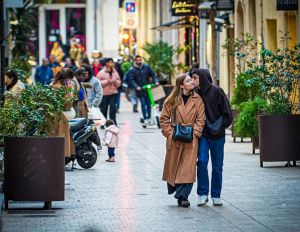Couple walking affectionately in a bustling Marseille street. Capturing city life and love.