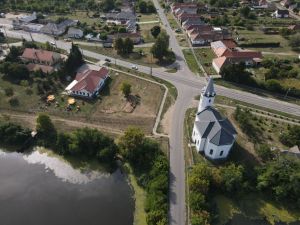 Aerial shot of Tunyogmatolcs, Hungary, showcasing the village landscape and a prominent church.