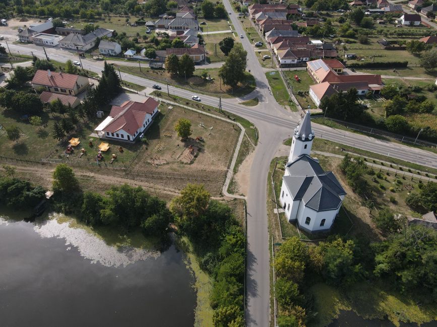 Aerial shot of Tunyogmatolcs, Hungary, showcasing the village landscape and a prominent church.